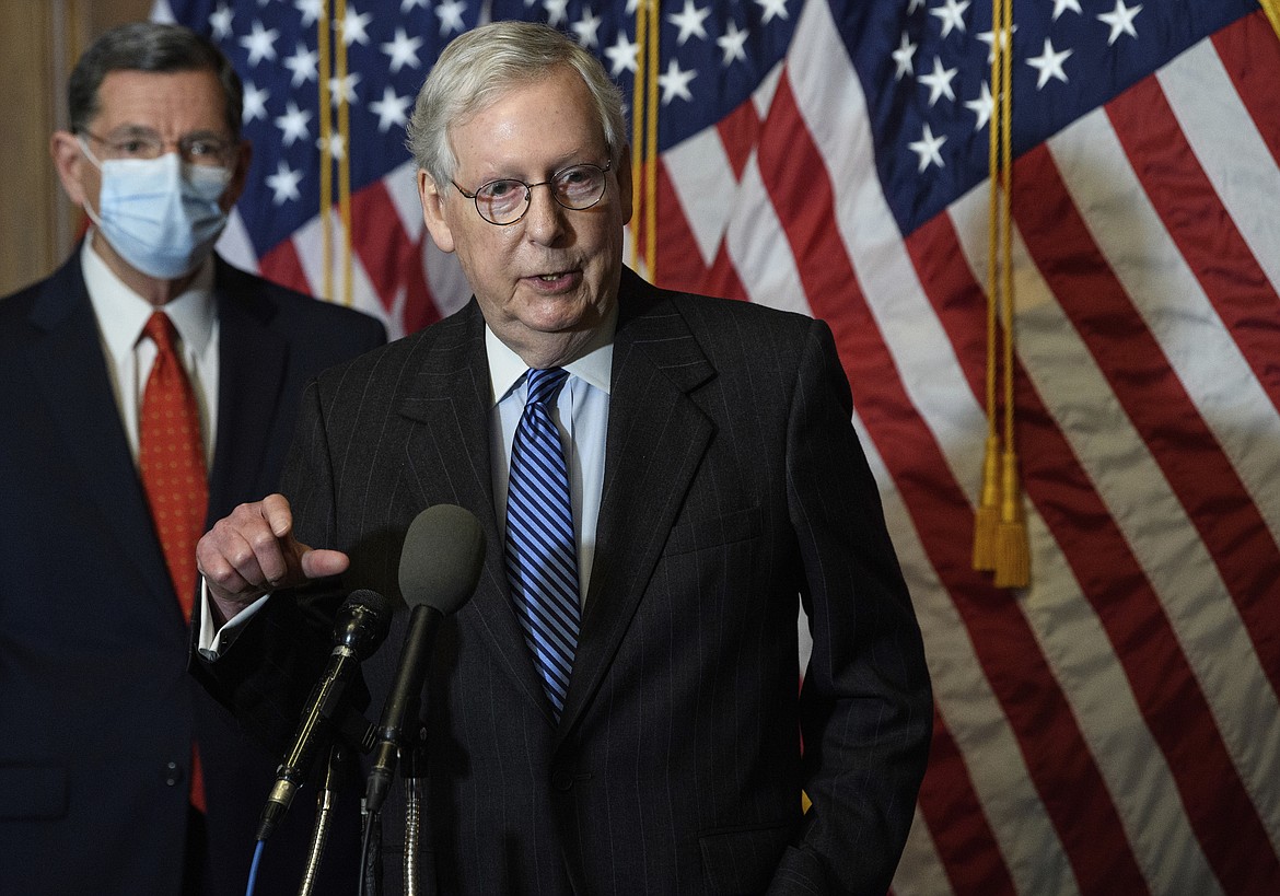 In this Tuesday, Dec. 15, 2020, file photo, Senate Majority Leader Mitch McConnell, of Kentucky, speaks during a news conference with other Senate Republicans on Capitol Hill in Washington, while Sen. John Barrasso, R-Wyoming, listens at left. “There will be another major rescue package for the American people," McConnell said in announcing an agreement for a relief bill, Sunday, Dec. 20, 2020, that would total almost $900 billion. “It is packed with targeted policies to help struggling Americans who have already waited too long.”