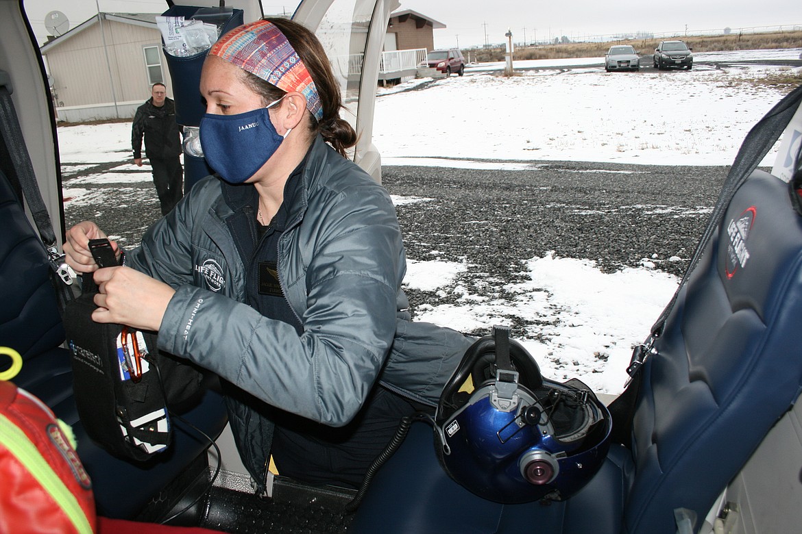 Flight nurse Jackie Marshall loads equipment into the Life Flight helicopter at the Moses Lake base.