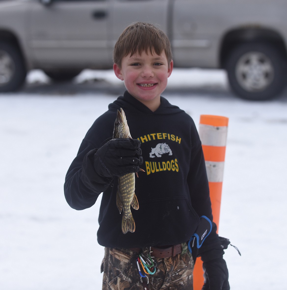 Eight-year-old Colton Dugan, of Kila, proudly displays a northern pike he caught at last Saturday's 50th annual Kalispell Sunriser Lions Club fishing derby at Smith Lake. (Scott Shindledecker/Daily Inter Lake)