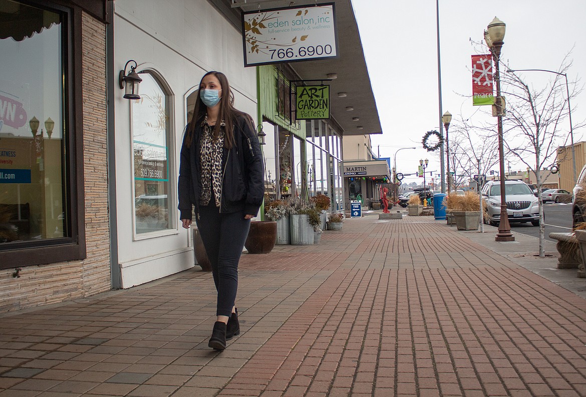 Lexi Smith, new executive director with the Downtown Moses Lake Association, takes a stroll down the sidewalk of Third Avenue getting a glimpse of the businesses she'll now be working closely with.