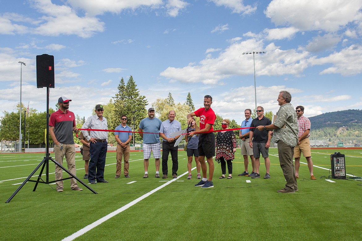 Sandpoint Mayor Shelby Rognstad cuts the ribbon to celebrate the completion of the artificial turf at War Memorial Field on Aug. 7. Members of the community, including several of the contractors that made the project possible, were on hand for the event.