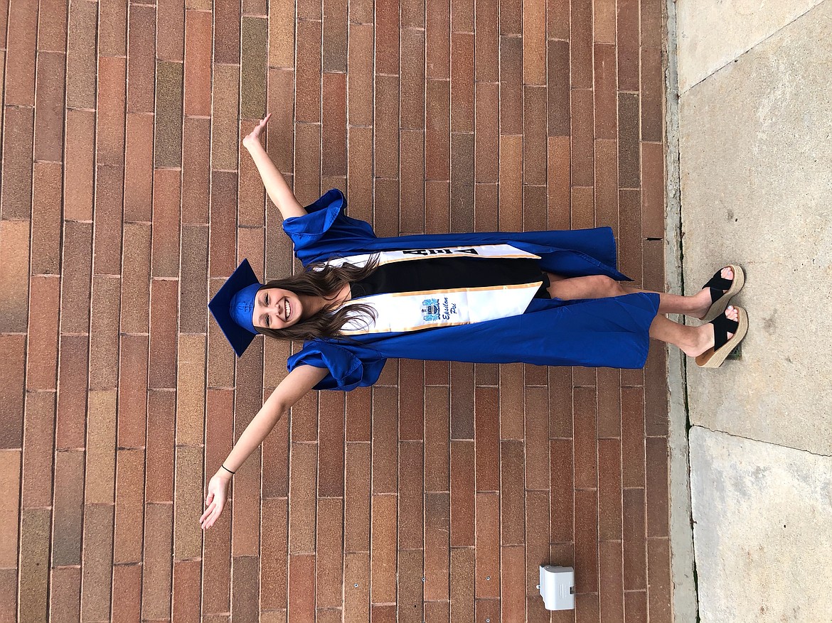 Lexi Smith celebrates with a pose after graduating from Boise State University in December, 2019.