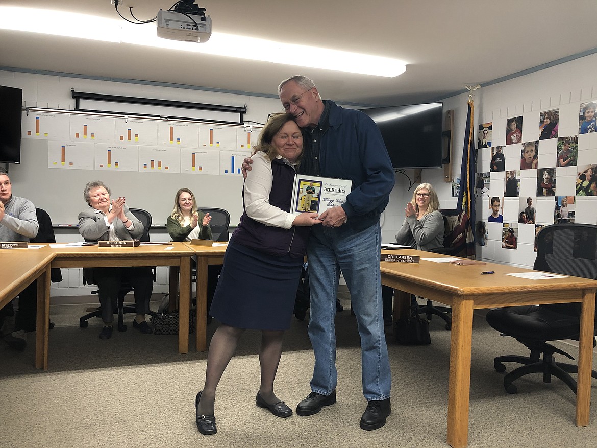January: Kellogg School District Superintendent Dr. Nancy Larsen gives former school board trustee Art Krulitz a big hug on Krulitz's last night on the board. The board honored Krulitz with a plaque for his years of service and a little send-off party after their meeting.