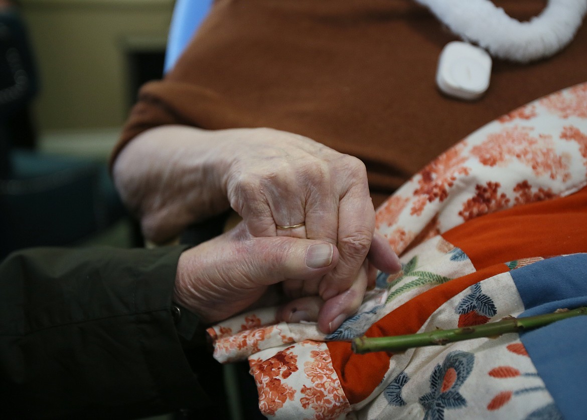 Glen and Nora Maier, married 70 years, three months and two days, hold hands during a visit Thursday at Honeysuckle Senior Living. Glen and Nora both contracted COVID-19 and couldn't see each other for a month, but have recovered and were reunited last Tuesday.