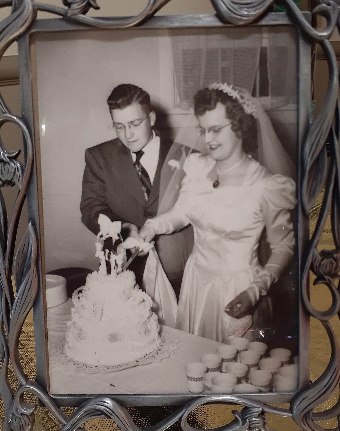 Glen and Nora Maier cut into their wedding cake in this photo from their wedding day, Oct. 1, 1950. The North Idaho couple have been through much in their 70-year marriage, including a recent bout with COVID-19. And yet, their love for each other is unwavering.