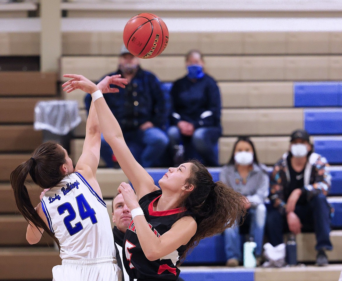 Mission's Sydney Brander (24) rises for a jump ball against Ronan's LaReina Cordova. (Courtesy of Stephen Hunt)