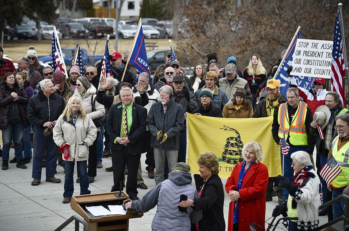 About 100 demonstrators gather on the north steps of the State Capitol for the "We the People" Freedom March in Helena, Mont. on Monday, Jan. 4, 2021. The 67th session of the Montana Legislature began amid dueling protests outside the Capitol over state directives to help prevent the spread of the coronavirus. Many Republicans chose not to wear masks during their swearing-in ceremonies. (Thom Bridge/Independent Record via AP)