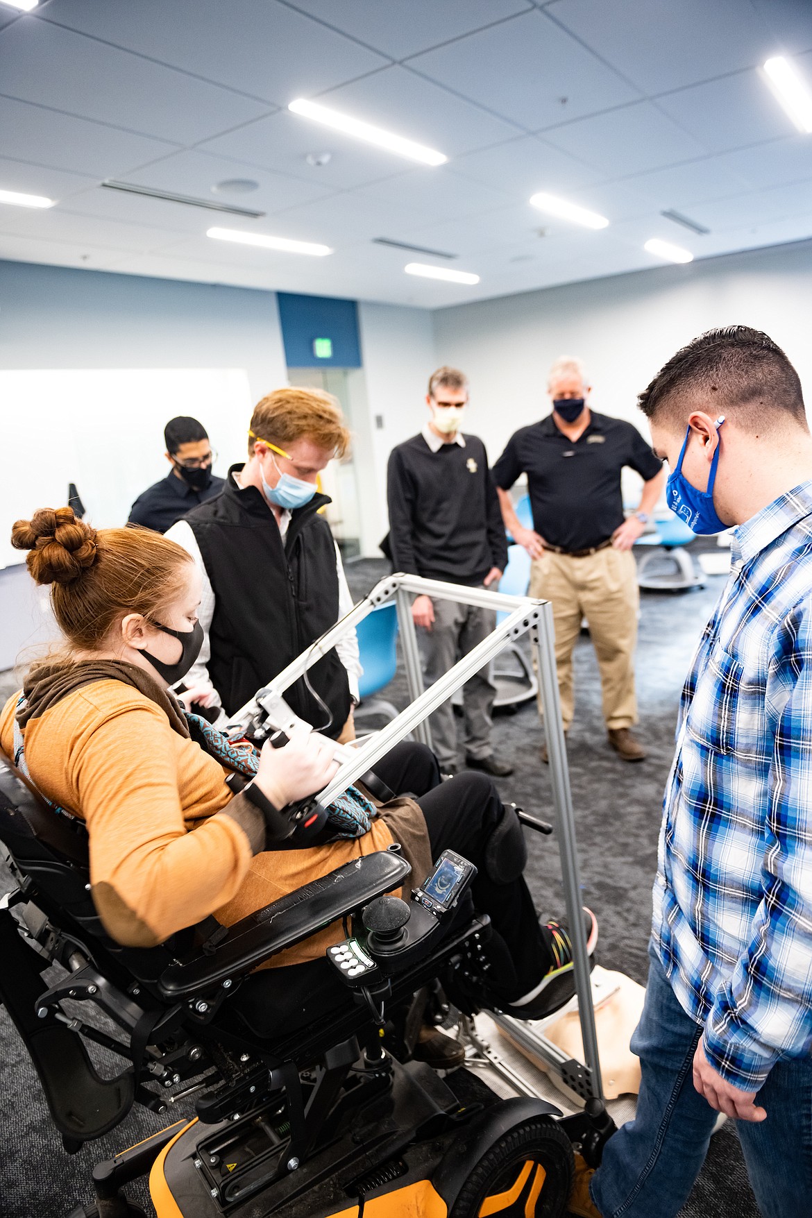 University of Idaho WWAMI Medical Education Program student Meagan Boll (left) test the assistive CPR device developed by U of I College of Engineering students Josh Sewell and Tyler Newman (left to right).