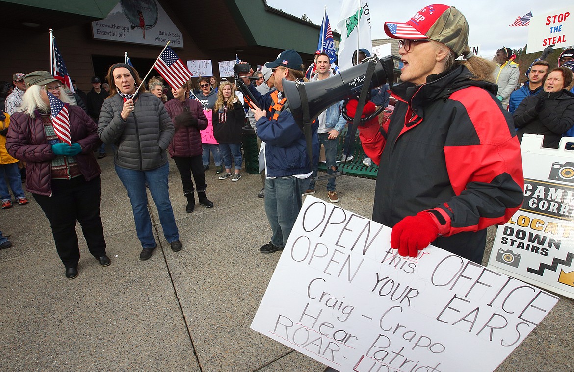 Ann Sneddon leads the crowd in chants during Tuesday's rally to support President Trump.