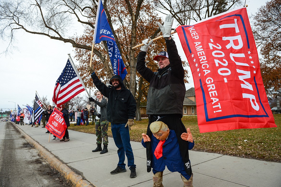 Kevin Extreme, from Proctor, waves a flag in support of Donald Trump while waving to passing motorists at Depot Park in Kalispell on Wednesday, Jan. 6. (Casey Kreider/Daily Inter Lake)
