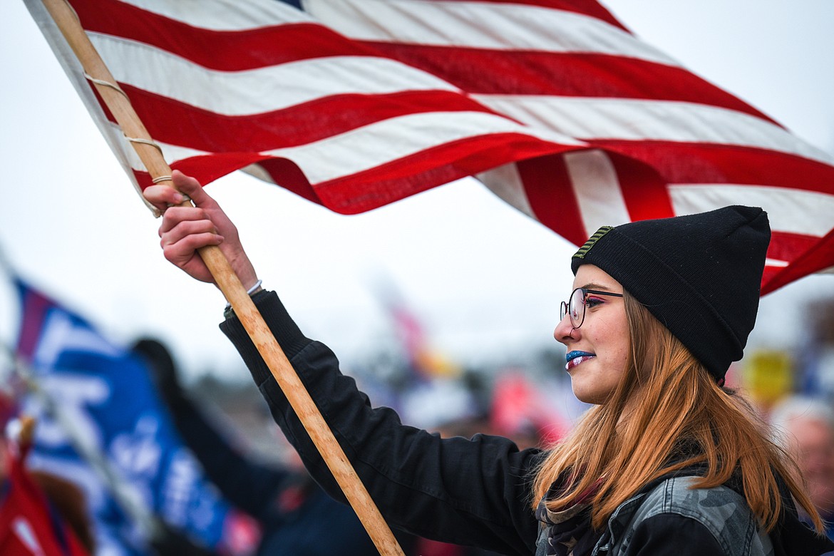 Karissa, who declined to provide her last name, waves an American flag as supporters of Donald Trump gathered at Depot Park on Wednesday, Jan. 6. (Casey Kreider/Daily Inter Lake)