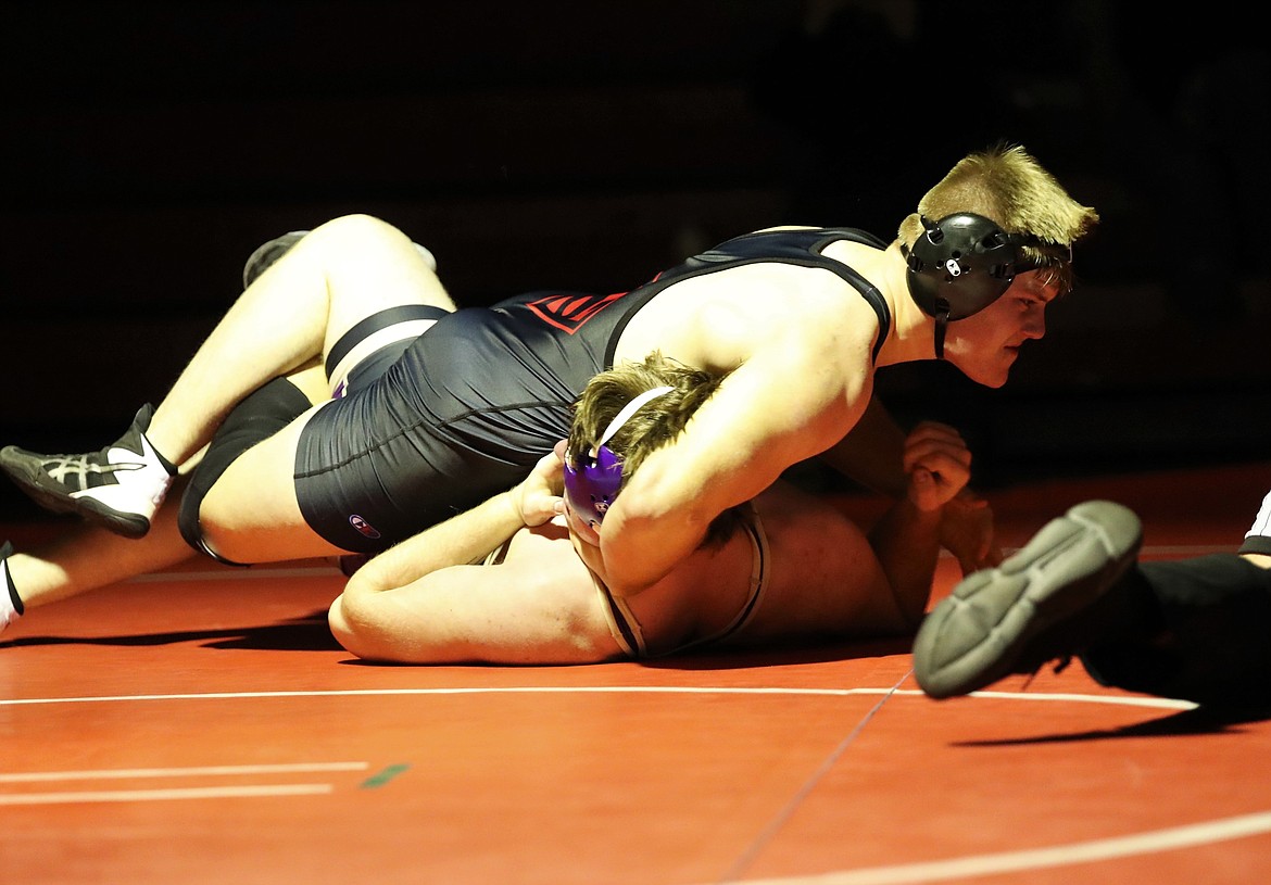 Tag Benefield (top) pins Kellogg's Carson Hudson in a 220-pound bout on Wednesday at Les Rogers Court.