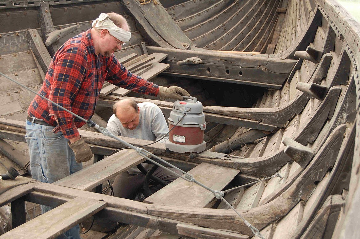 Andrew Woods and David Nordin working on the interior construction of a replica Viking longboat that didn’t have benches for the oarsmen, who instead used their own individual chests containing personal possessions to save space.