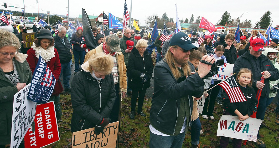 Some of the crowd at Wednesday's rally in Coeur d'Alene bows their heads in prayer.