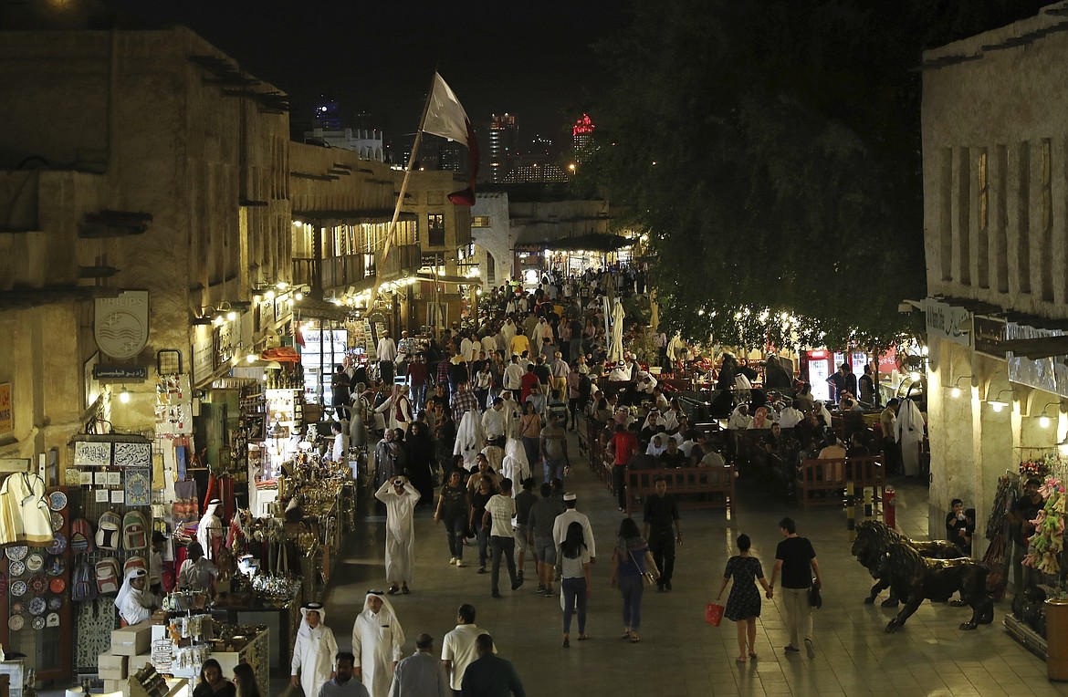 In this Monday, May 13, 2019 file photo, people walk at Souq Waqif in Doha, Qatar. Qataris awoke to a surprise blockade and boycott by Gulf Arab neighbors 3 1/2 years ago, and this week were jolted again by the sudden announcement that it was all over.