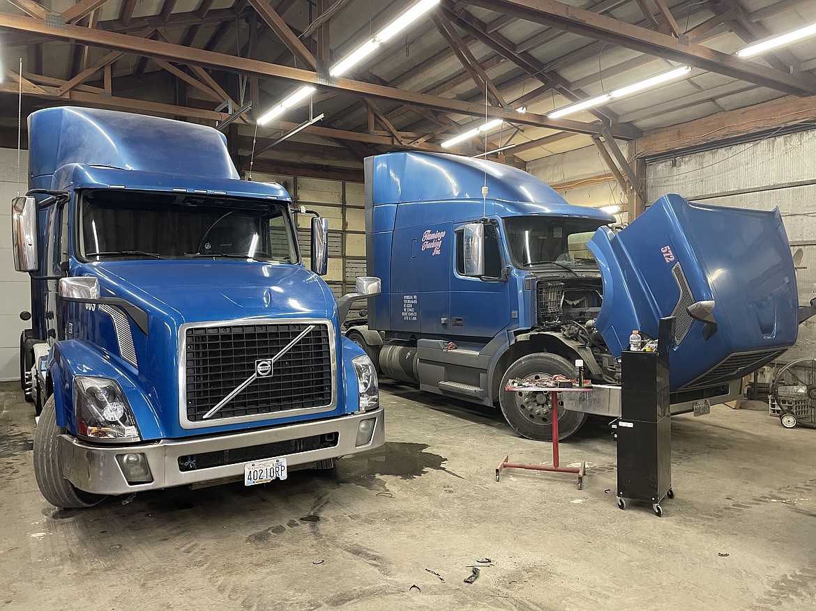 Trucks sitting for repair work inside Flamingo Trucking's repair bay.