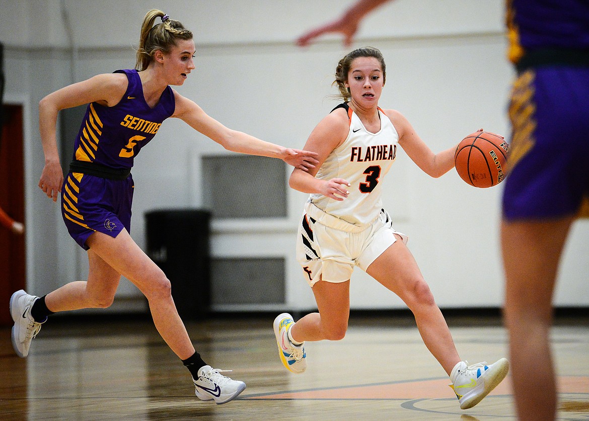 Flathead's Kuyra Seigel (3) brings the ball upcourt against Missoula Sentinel's Brooke Stayner (5) in the first half at Flathead High School on Thursday. (Casey Kreider/Daily Inter Lake)