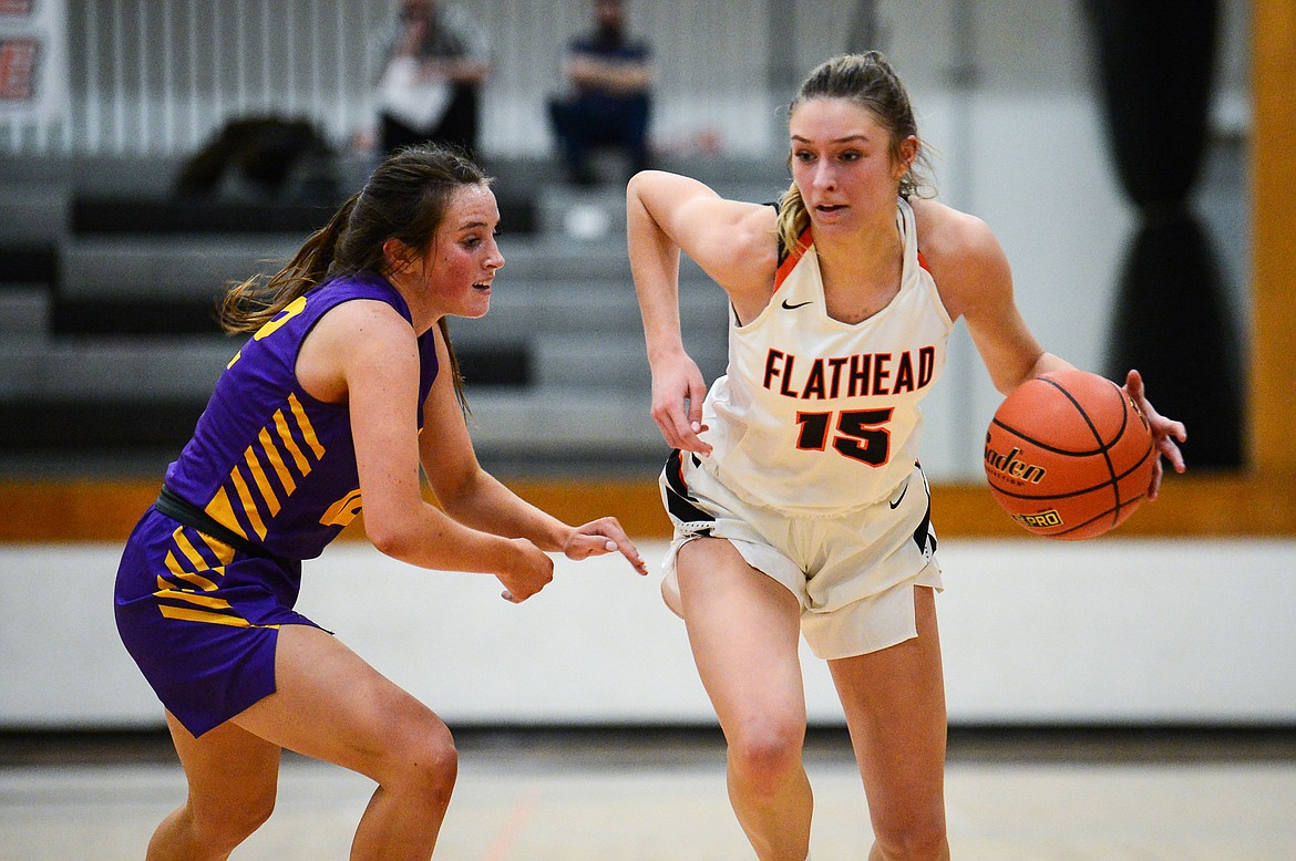 Flathead's Clare Converse (15) brings the ball upcourt against Missoula Sentinel's CC Size (12) in the first half at Flathead High School on Thursday. (Casey Kreider/Daily Inter Lake)