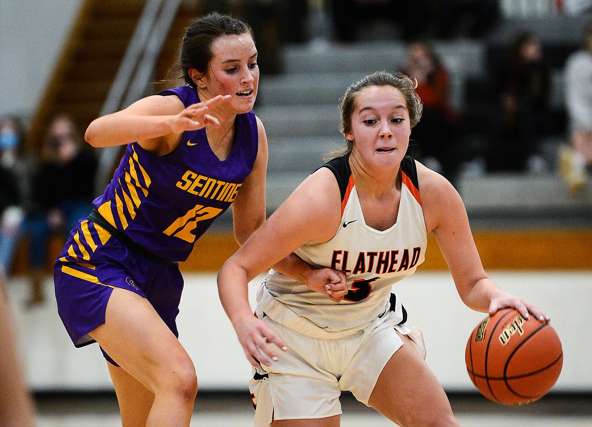 Flathead's Kuyra Seigel (3) brings the ball upcourt against Missoula Sentinel's CC Size (12) in the first half at Flathead High School on Thursday. (Casey Kreider/Daily Inter Lake)