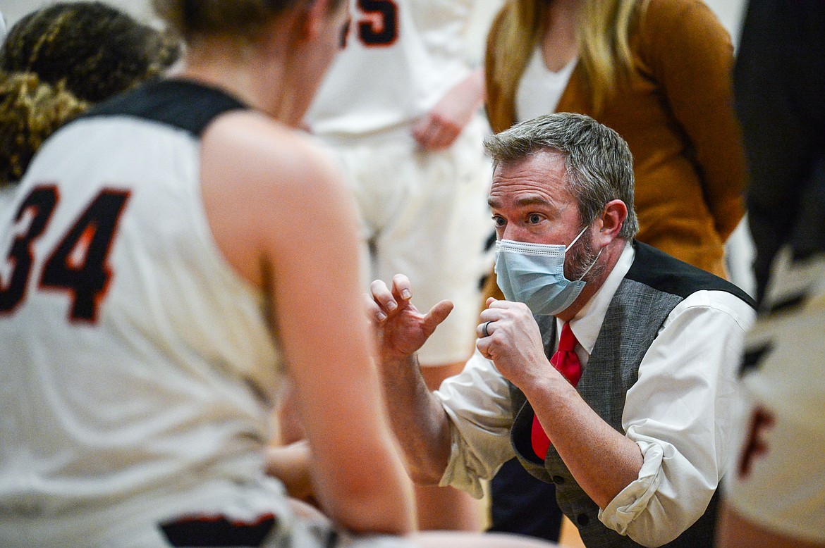 Flathead Bravettes head coach Sam Tudor speaks to the team during a timeout in the third quarter against Missoula Sentinel at Flathead High School on Thursday. (Casey Kreider/Daily Inter Lake)