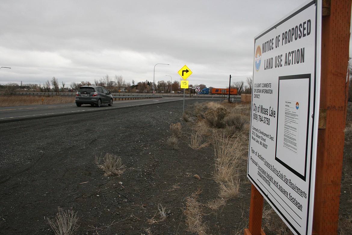 A car rolls past a sign announcing a previous public hearing for the Love's Travel Stop project on Idaho Road. The building permit for the project hadn't been received as of Jan. 7.