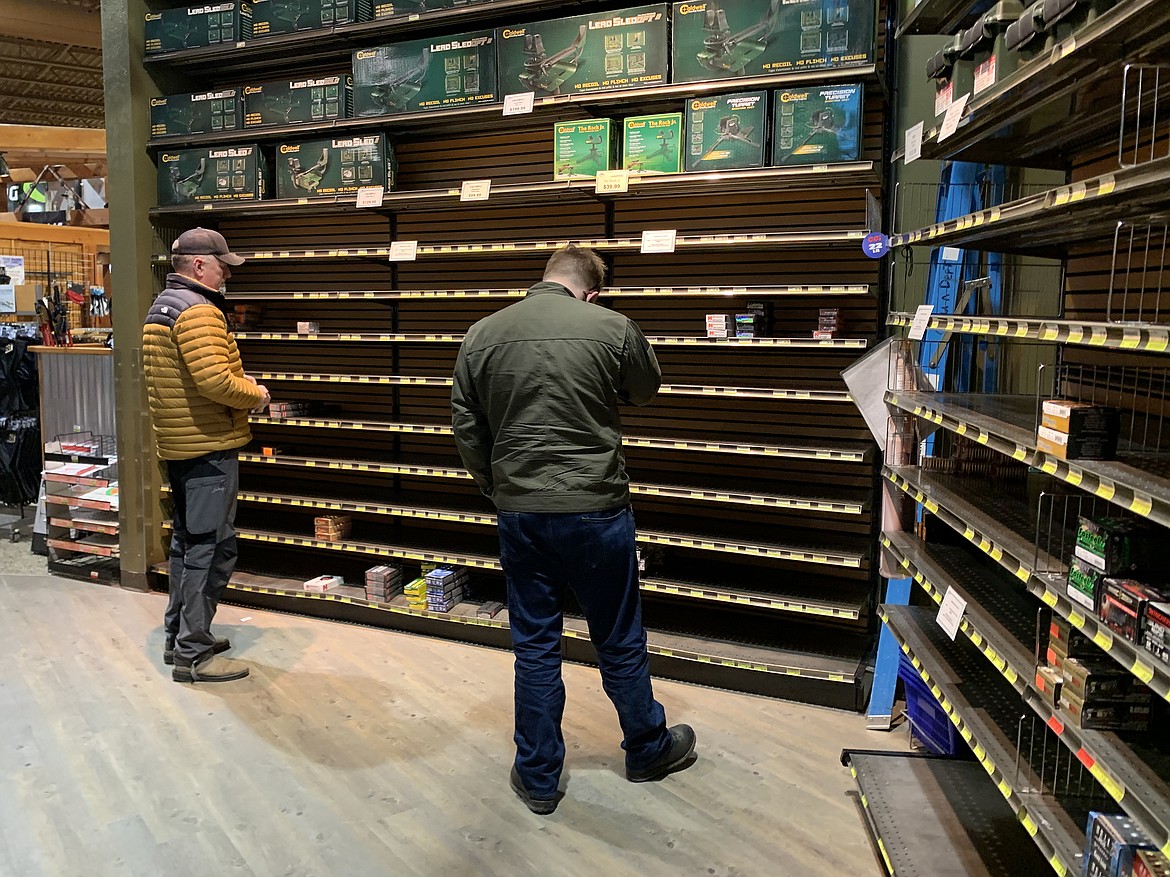 Customers look over the sparse selection of ammunition at the Kalispell Sportsman & Ski Haus Wednesday as a shortage has left the shelves bare for months. (Jeremy Weber/Daily Inter Lake)