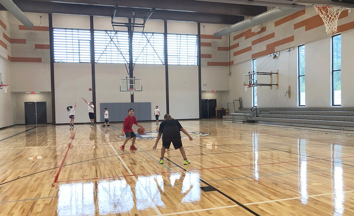 Hoksila Sakeema Iron Cloud dribbles the basketball on the court of the new Coeur Center in Worley.