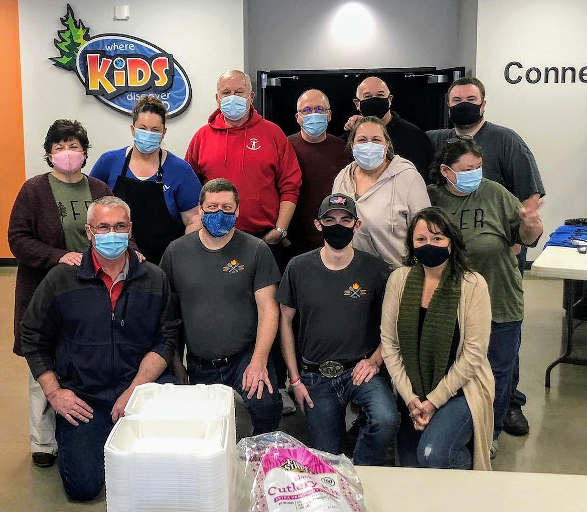 Volunteers from the event smile for the camera before they get to work. Front row from left: Brad Kitchen, Garren Taylor, Logan Castonguay and Christy Jacobs. Middle: Jill Towson and Saundra Rowland. Back: Rhonda Kitchen, Nancy Taylor, Larry Curry, Gene Jacobs, Jim Towson and Ryan Stice.