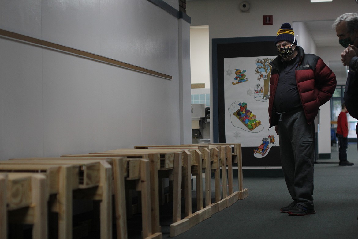 Rotary president Harry Loskill looks at the desks the group built for students Friday morning at Idaho Hill Elementary School.