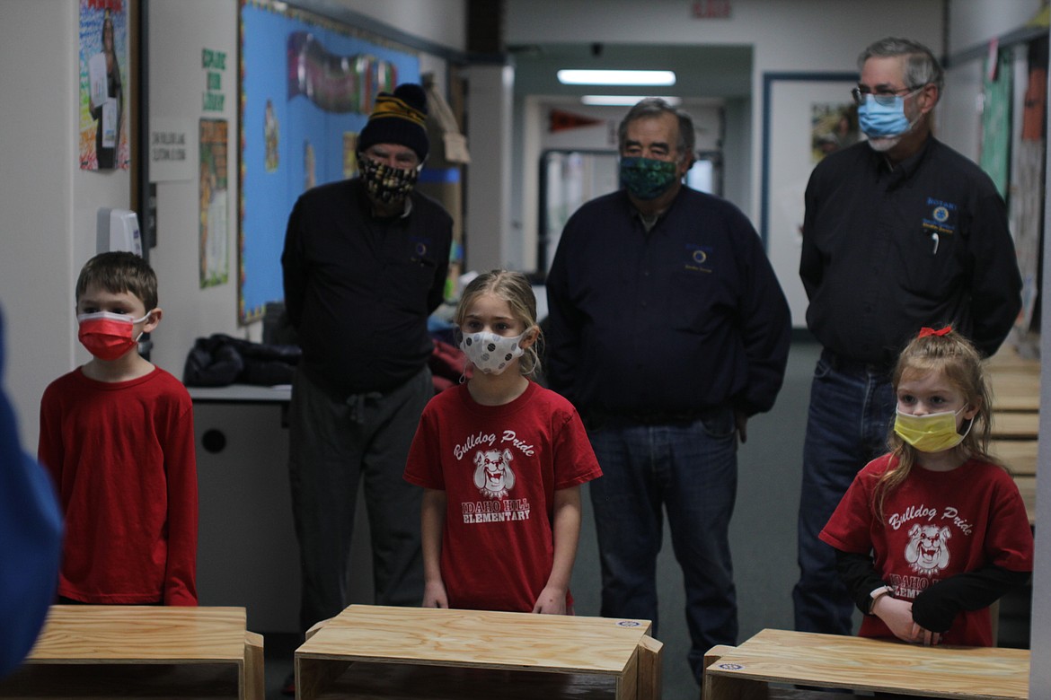 Left to right: Idaho Hill second-grader Keith Campbell and first-graders Abigail Floyd and Emma Toews pose for a photo alongside Rotarians Harry Loskill (upper left), Brad Mingay and Joe Olmstead Friday morning at Idaho Hill Elementary School.