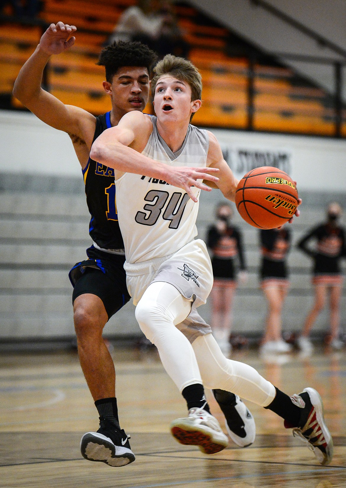 Flathead's Joston Cripe (34) heads to the hoop past Missoula Big Sky's Louis Sanders (12) in the first quarter at Flathead High School on Saturday. (Casey Kreider/Daily Inter Lake)