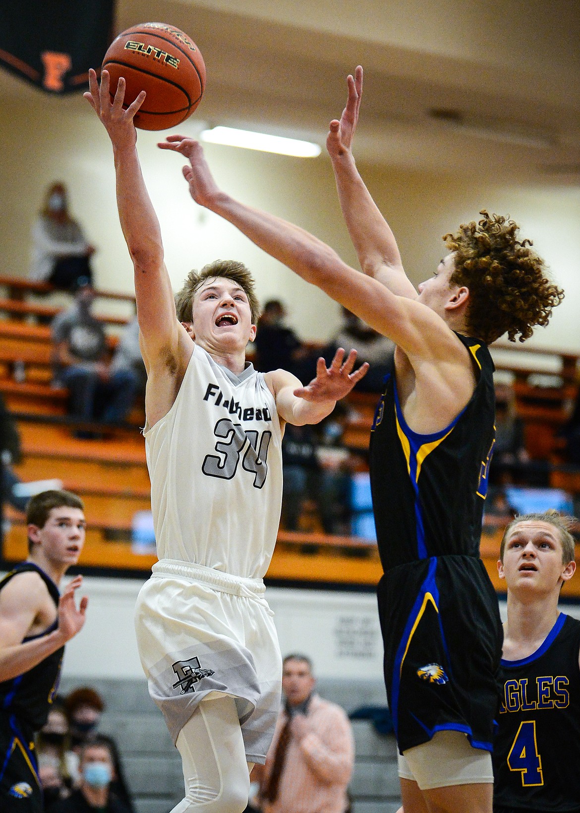 Flathead's Joston Cripe (34) is fouled on his way to the basket by Missoula Big Sky's Kolby Jensen (32) in the second half at Flathead High School on Saturday. (Casey Kreider/Daily Inter Lake)