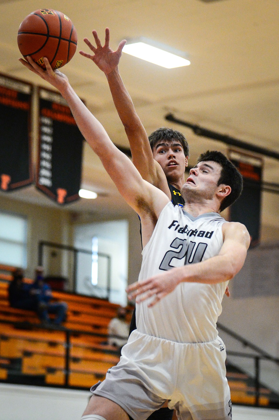 Flathead's Gabe Adams (24) drives to the basket past Missoula Big Sky's Chaz LaDue (13) in the first half at Flathead High School on Saturday. (Casey Kreider/Daily Inter Lake)