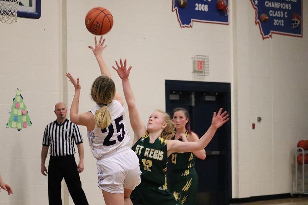 Clark Fork's Payton Milender is guarded by St. Regis' Macy Hill during the game Saturday night. (Kami Milender photo)