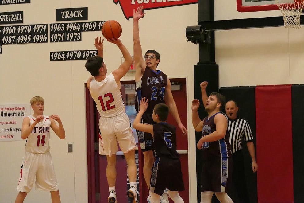 Hot Springs’ Kyle Lawson (12) tries to shoot over Carson Callison of Clark Fork during a game last week. (Chuck Bandel/Valley Press)