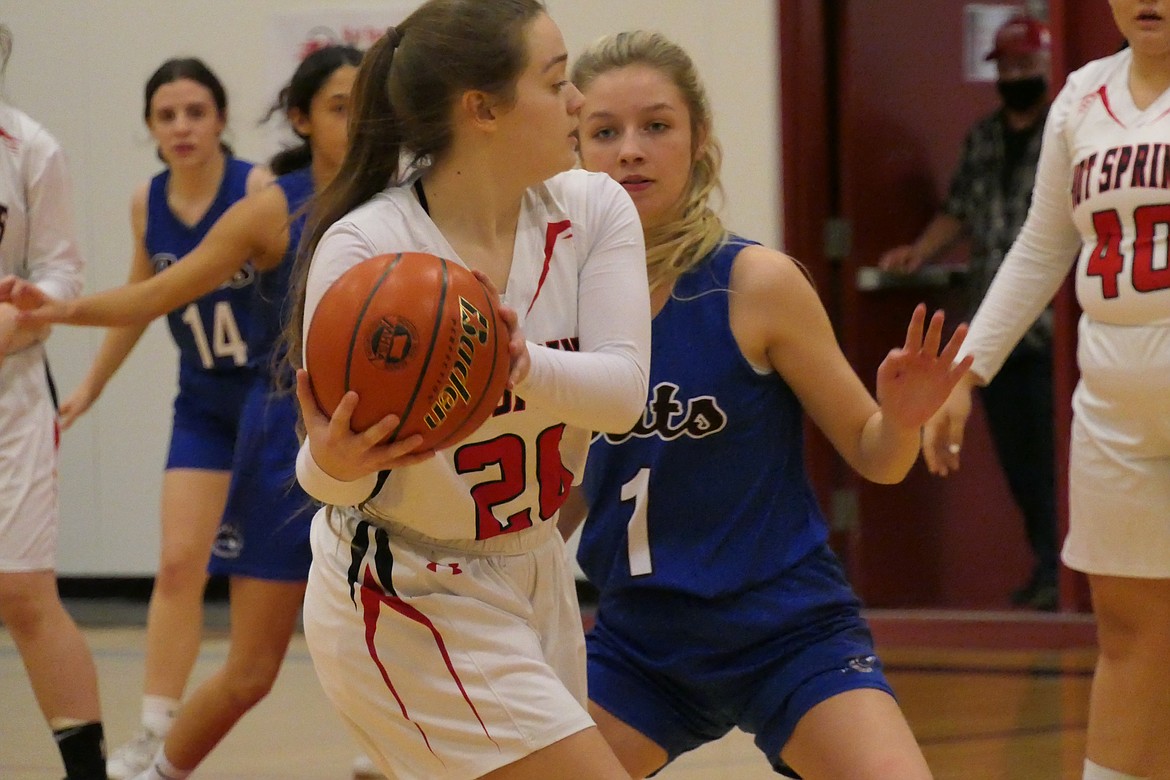 Hot Springs girls basketball player Sam Carr tries to get past the defense of Clark Fork’s Darby Haskins (1), who led all scorers with 20 points in the Mountain Cats win. (Chuck Bandel/Valley Press)