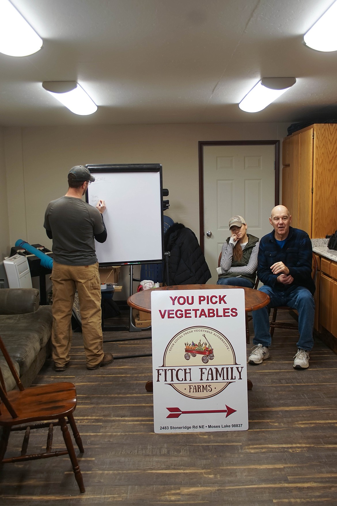 Chris Fitch, left, of Fitch Family Farms runs Saturday meeting with his wife Sarah, center, and father-in-law Tim.