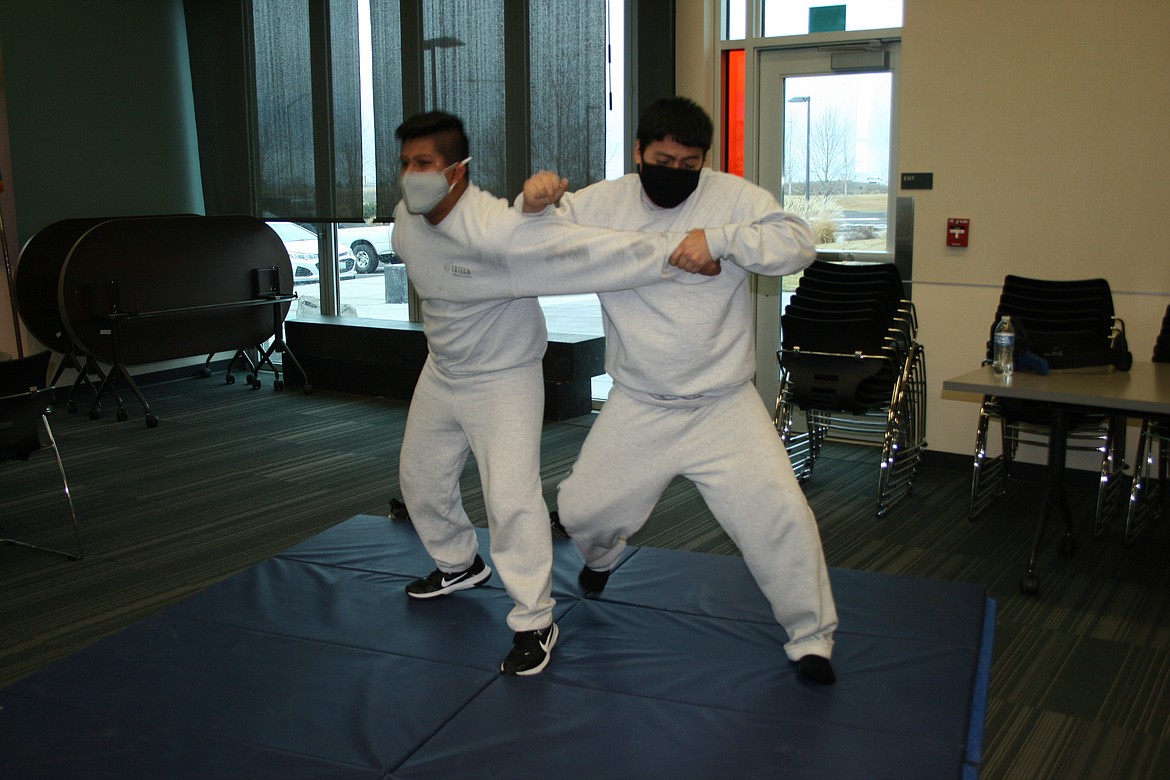 Alex Penida (right) practices law enforcement self-defense techniques with Christoper Martinez (left). Both are students in the criminal justice class at the Columbia Basin Technical Skills Center in Moses Lake.