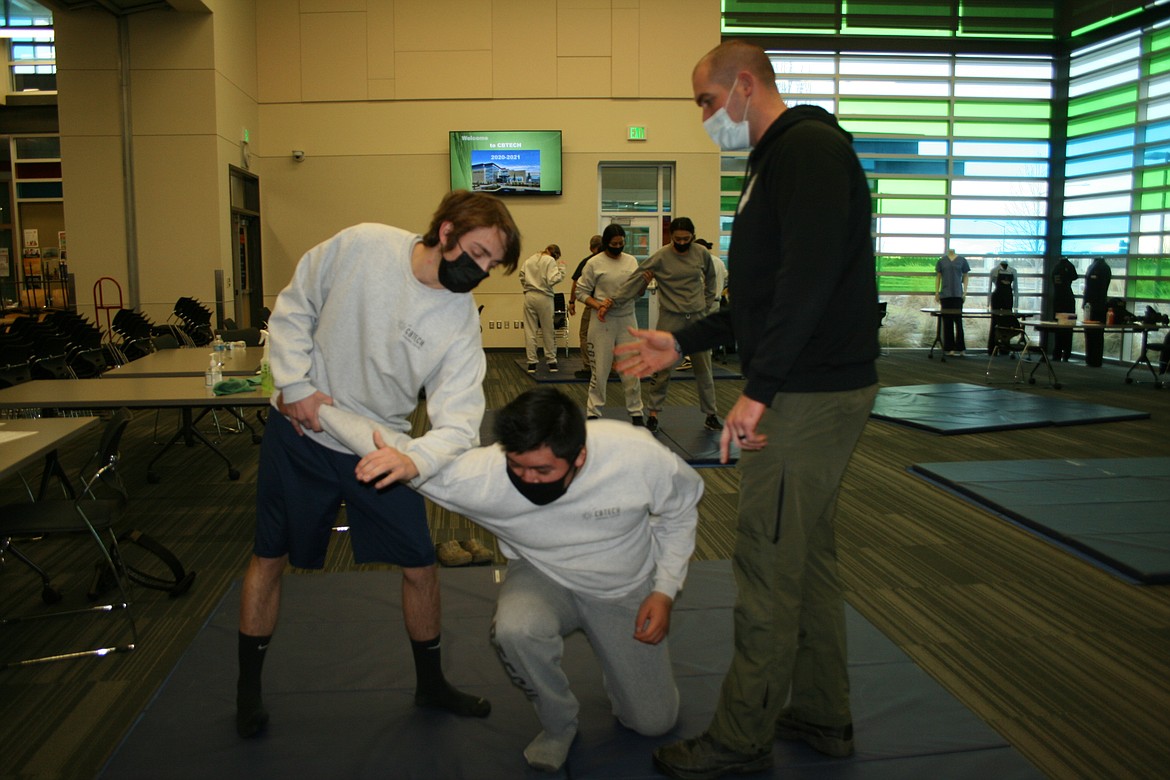 Moses Lake Police Department officer Nick Stewart (right) gives instruction in proper defensive techniques to Columbia Basin Technical Skills Center criminal justice students Jordan Cohee (left) and Osvaldo Garduno (center). The skills center is in Moses Lake.
