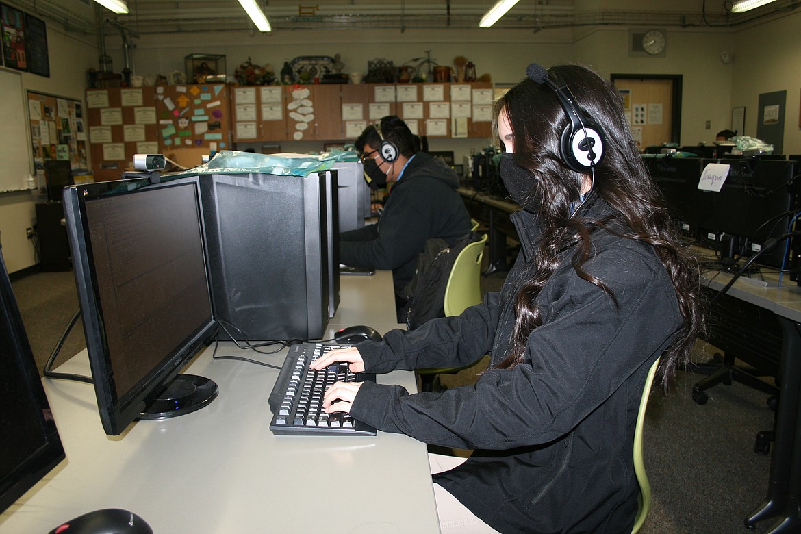 Audrey Tran (foreground) and Angel Torres (background) work on exercises in the TEALS computer programming class at Columbia Basin Technical Skills Center Friday. The program brings industry professionals into high school classrooms.