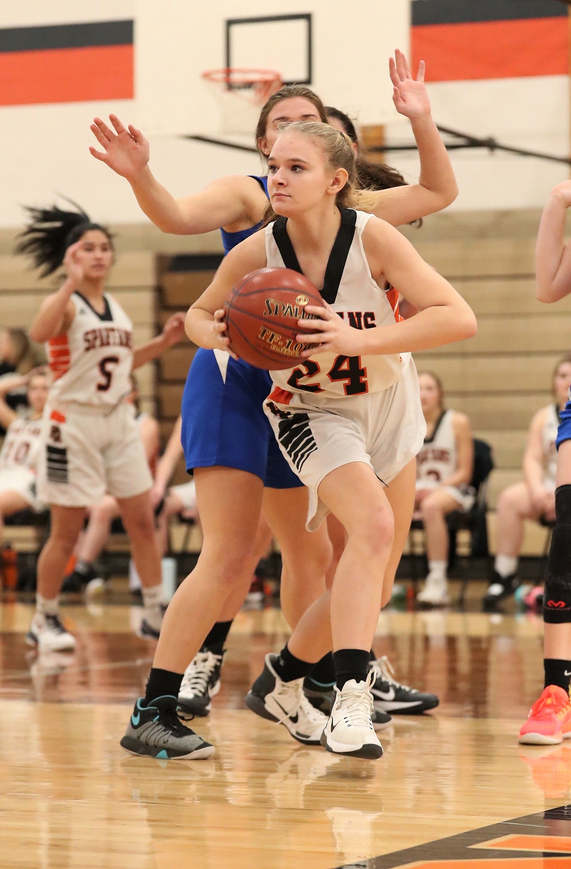 Freshman Helena White secures a rebound and looks to kick the ball out to a teammate during a game against North Idaho Christian on Jan. 4 at PRLHS.