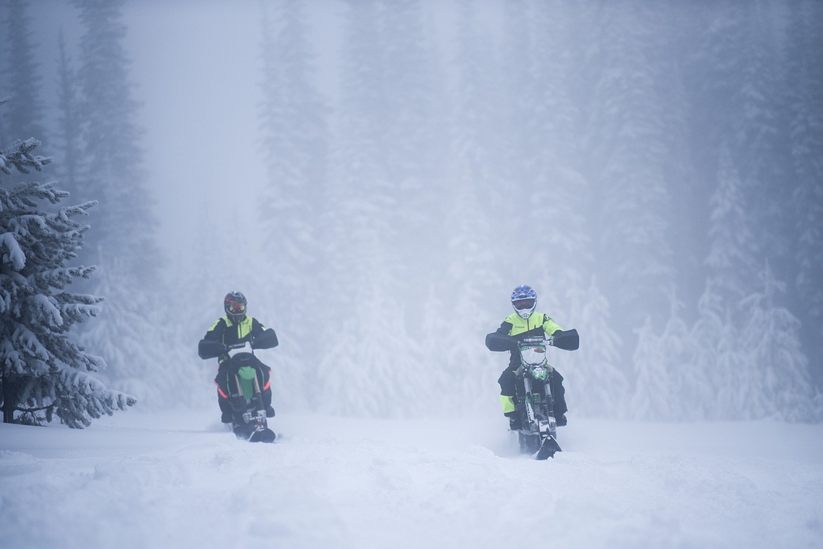 Kyle Allred, left, trails Daily Inter Lake reporter Bret Serbin while Allred teaches her the basics of riding a snow bike near Blacktail Mountain Ski Area on Thursday, Jan. 7. (Casey Kreider/Daily Inter Lake)