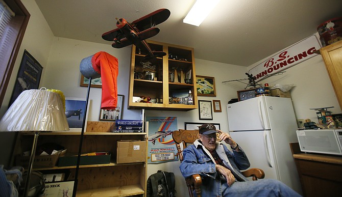 Hangar owner Gene Soper, 91, adjusts his Coeur d'Alene Airport hat as he shares stories from his years in aviation during a visit to his S&S Hangar. Soper has had a hangar since 1990 and knows how much of a generator the airport is for the economy. "The big money doesn't come in on a Greyhound bus," he said.