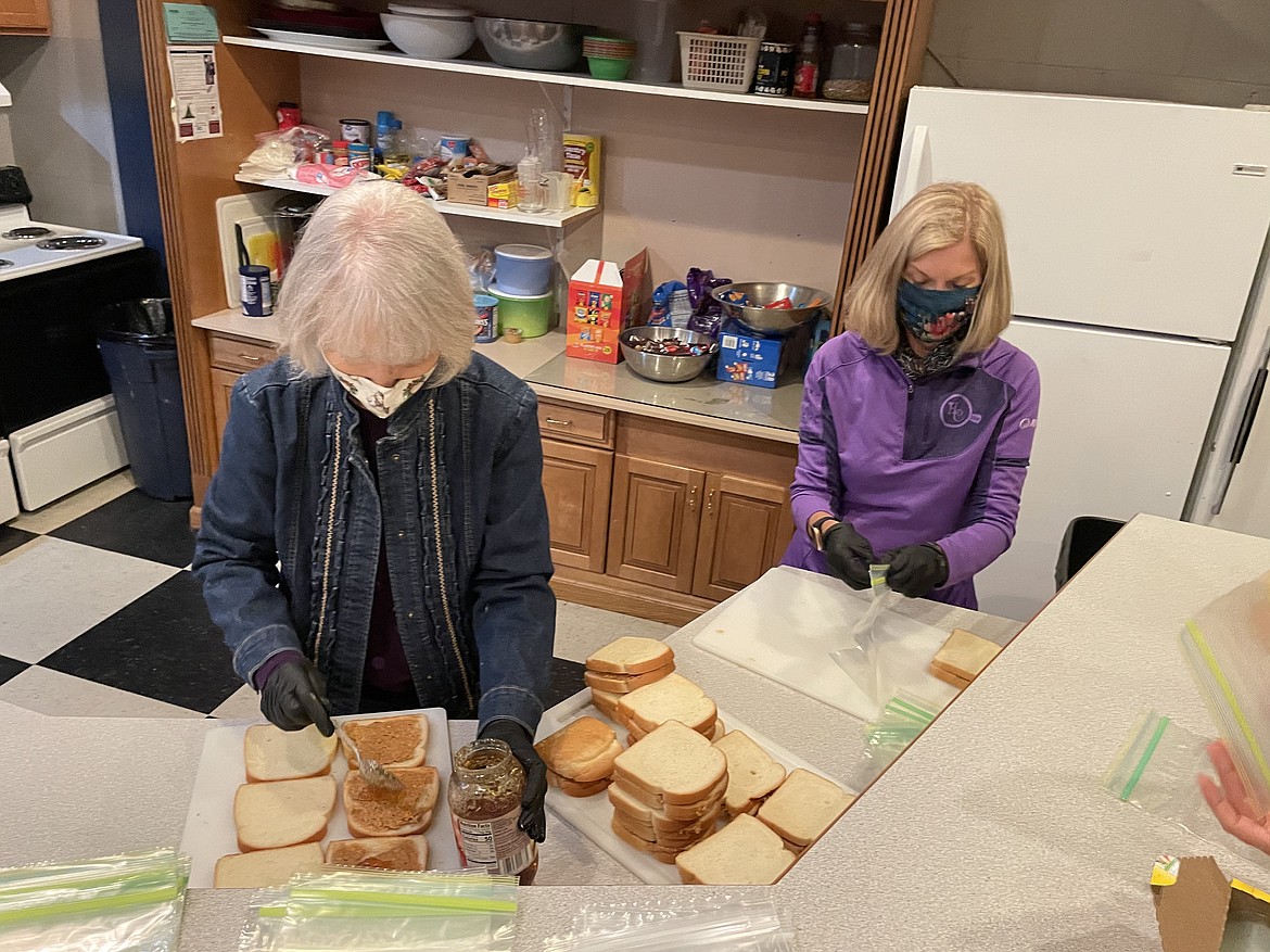 Volunteers Carol Bridges and Becky Meyer help makes sandwiches for the homeless Tuesday night at Youth Dynamics in downtown Moses Lake. It's something Care Sacks, formed by Moses Lake graphic designer Michelle Boetger, has done every Tuesday since early 2017.