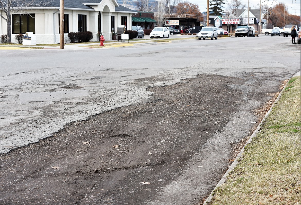 A broad section of the top layer of is missing from Second Street near its intersection with Third Avenue. (Scot Heisel/Lake County Leader)