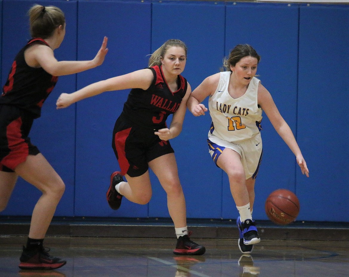 Freshman Lily Reuter (right) dribbles the ball up the court on Tuesday.