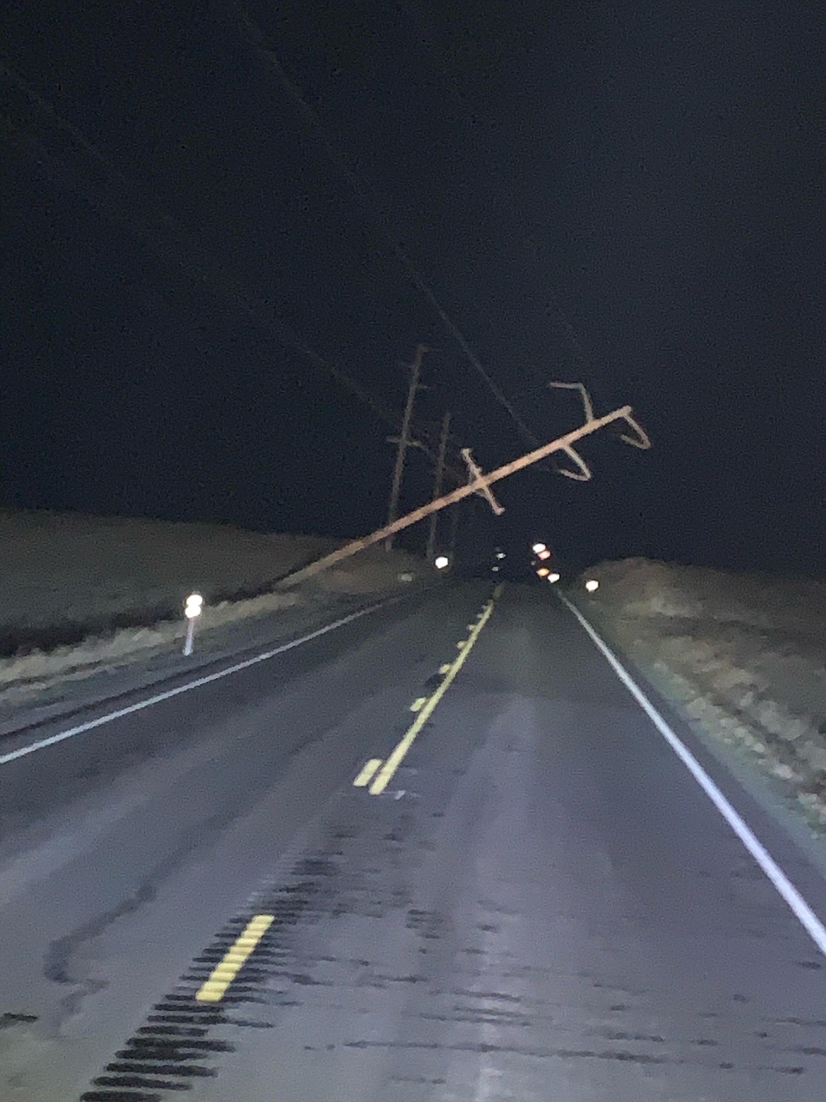 A partially downed power pole on Road U NE was one of the casualties of the windstorm early Wednesday morning.