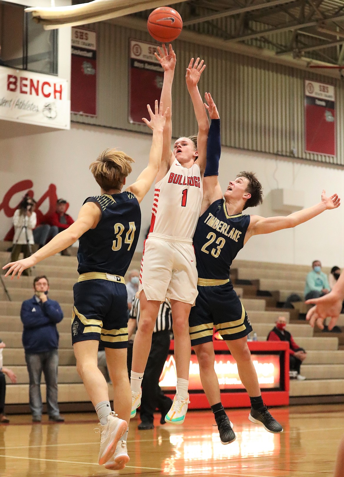 Sophomore Colin Roos pulls up for a jumper over a pair of Timberlake defenders on Thursday.