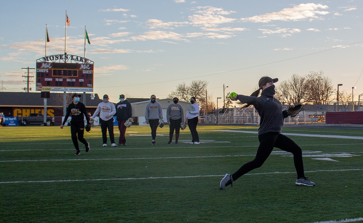 Senior Ciarrah Knoll throws the ball back to head coach Michael Hofheins during a warmup drill at Lions Field on Thursday afternoon in Moses Lake.