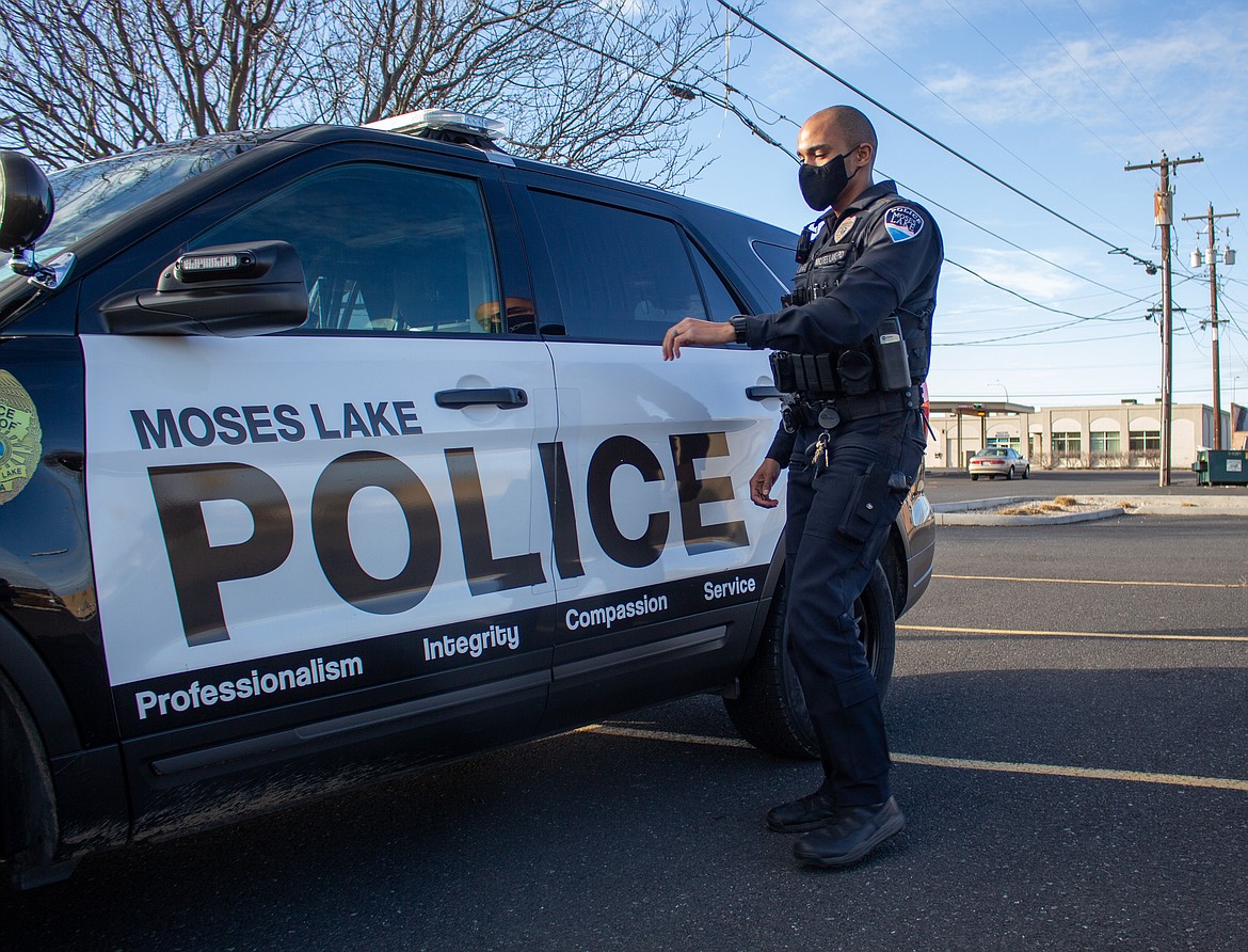 MLPD patrol officer Yoni Mengist walks back to his patrol vehicle on Thursday afternoon in Moses Lake.